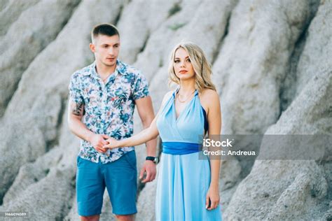 Blonde Girl In A Light Blue Dress And A Guy In A Light Shirt In A