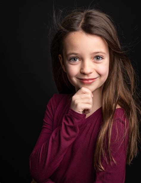 Premium Photo Portrait Of Cute Girl Standing Against Black Background