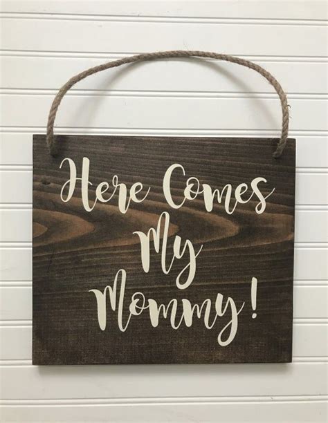 A Wooden Sign That Says Here Comes My Mommy