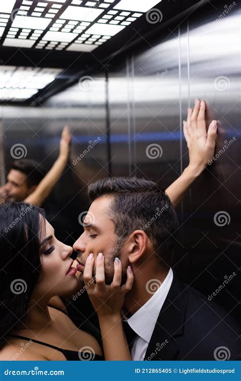 Sensual Brunette Woman Kissing Boyfriend In Stock Image Image Of Suit Indoors