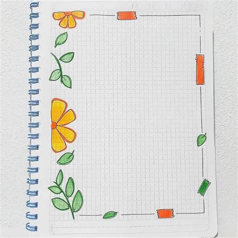 A Notebook With An Orange Flower And Green Leaves Drawn On It Sitting