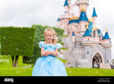 Little happy girl in princess dress at fairy-tale park Disneyland Stock ...