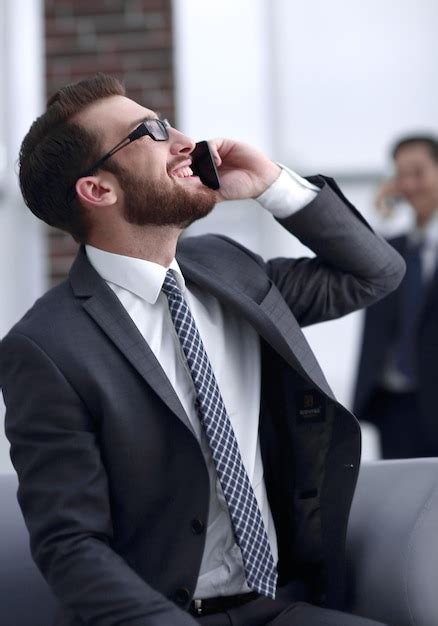 Premium Photo Charming Businessman Talking On Phone In A Modern Building