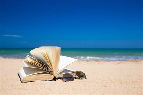 Premium Photo Book And Sunglasses On Tropical Beach