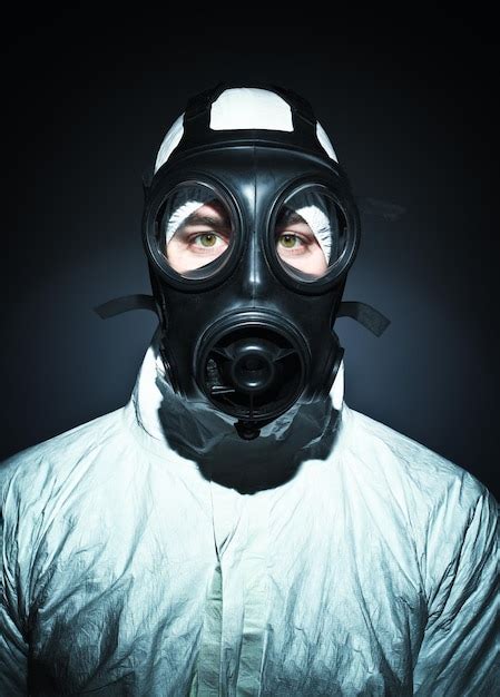 Premium Photo Portrait Of Man Wearing Gas Mask Against Black Background