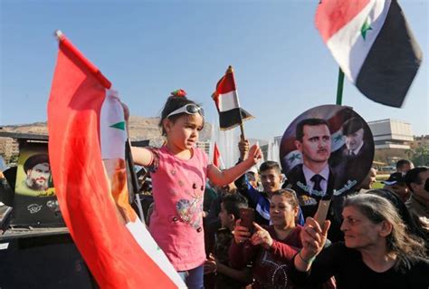 Syrians Defy Strikes Gather In Damascus Squares Holding Flags Of Iran