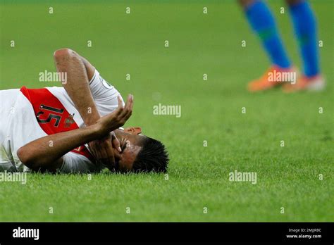 Peru's Carlos Zambrano reacts after colliding with Brazil's Gabriel ...