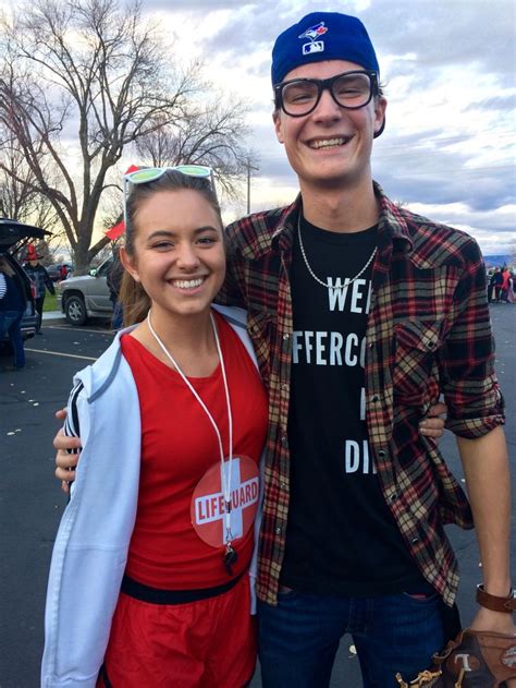 a man and woman standing next to each other in front of a parking lot ...