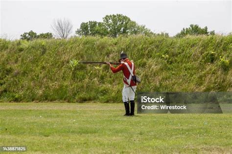 18th Century Soldier Is Firing A Musket Stock Photo Download Image