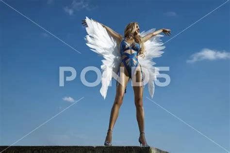 Beautiful Sexy Blonde Woman In Blue Elegant Lingerie And Angel Wings Is