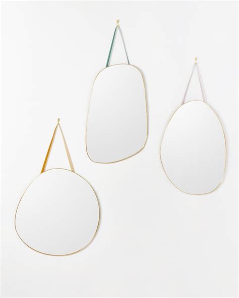 Three Mirrors Hanging On The Wall One With A Gold Frame And Two