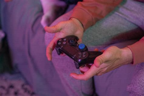 A Person Holding A Playstation Game Controller · Free Stock Photo