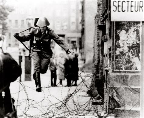 East German Border Guard Konrad Schumann Jumping Over Barbed Wire Line