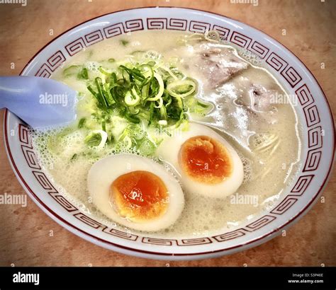 Hakata ramen, Hakata style ramen noodles in pork broth, with hanjuku soft boiled egg, green ...