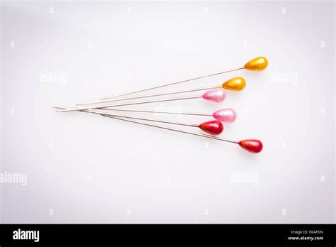 Many sewing push pins isolated on white background Stock Photo - Alamy 