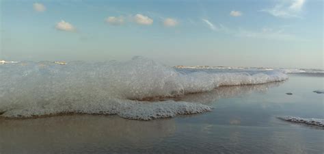 Sea Foam Waves And Naked Woman Feet On A Sand Beach Girl Legs