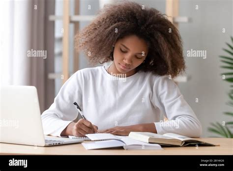 Focused African American School Girl Studying Writing Essay Doing