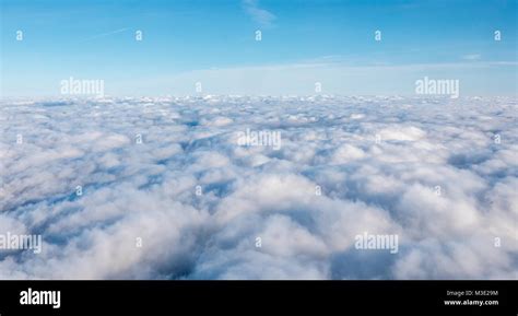 White Dense Cloud Covering With Blue Open Skies Above Stock Photo Alamy