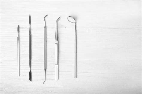 Premium Photo | Set of dentist tools on wooden background