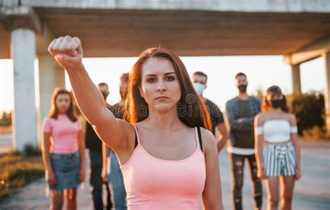 Woman On The Front Of Crowd Group Of Protesting Young People That