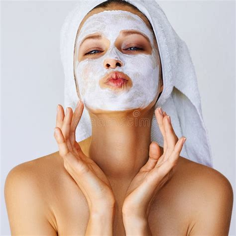 Beautiful Young Woman Applying Facial Mask On Her Face With Brush Skin