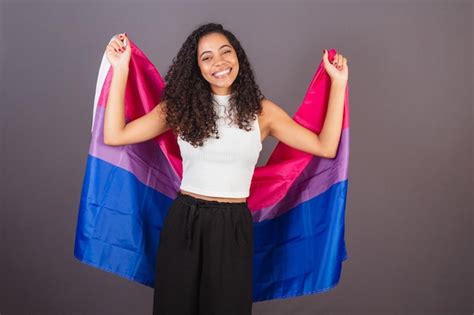 Premium Photo Young Brazilian Black Woman Raising Bisexual Flag