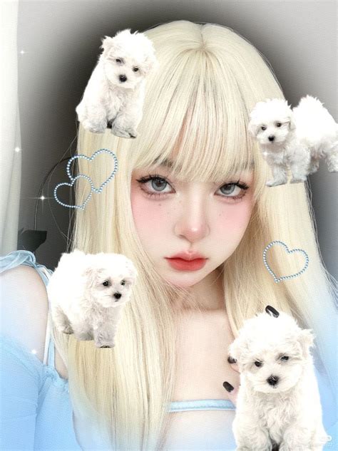 A Woman With Long Blonde Hair Holding Two Small White Poodles In Front