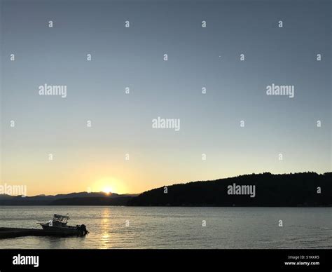 BOAT ON WATER AT SUNSET Stock Photo - Alamy