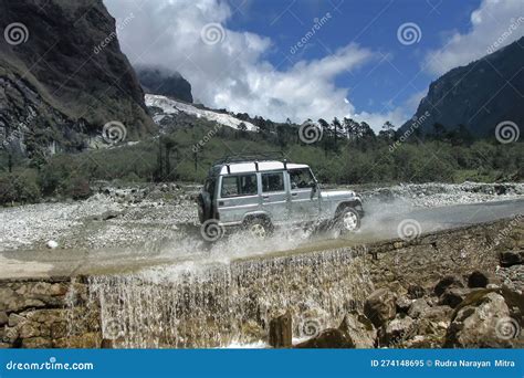 Tourist Car Crossing Fountain at Yumthang Valley or Sikkim Valley of Flowers Sanctuary ...