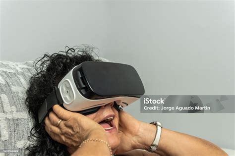 Senior Brunette Curly Haired Woman Gaping In The Virtual Reality