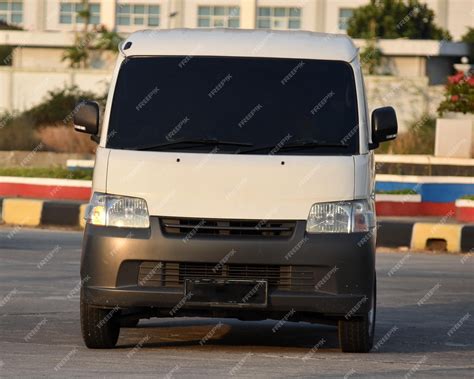 Premium Photo | White courier van passing