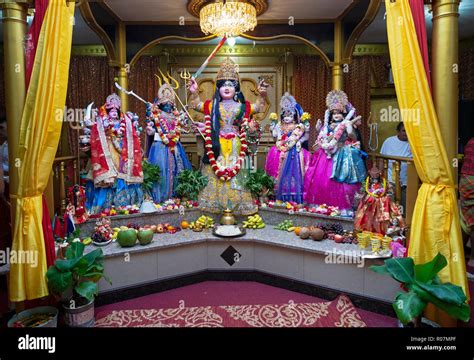 The altar at a Hindu temple in Queens with several statues of deities Stock Photo - Alamy