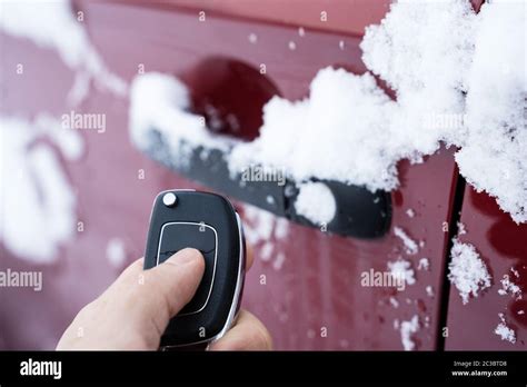 Man Trying To Open Frozen Car Door With Remote Stock Photo Alamy