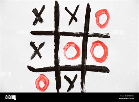 The Game Of Tic Tac Toe Is Drawn On Paints On White Paper Play And