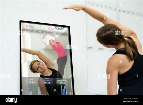 Smart Mirror Workout And Exercise Class. Women Doing Fitness Stock Photo - Alamy