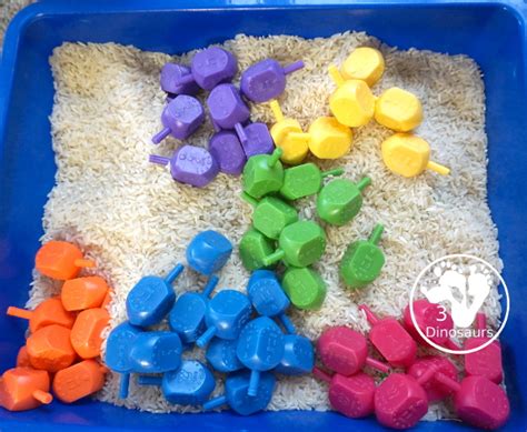 Dreidel Sensory Bin With Rice 3 Dinosaurs