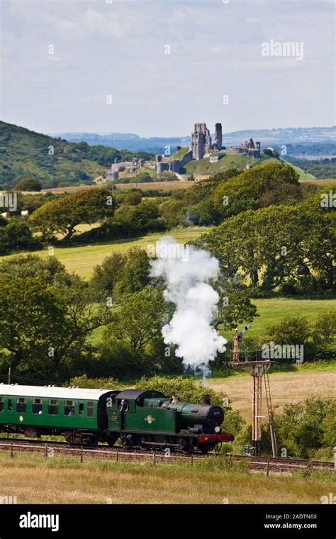 Swanage Railway Steam Train With Corfe Castle In The Background Stock