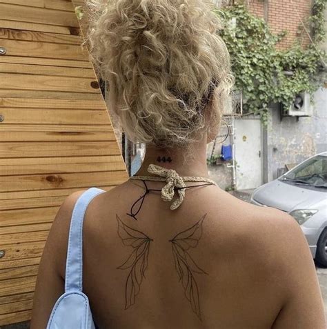 A Woman With A Tattoo On Her Back