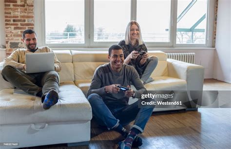 Friends Playing Computer Game At Home High Res Stock Photo Getty Images