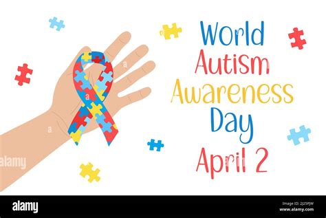 World Autism Awareness Day Hand Holding Awareness Ribbon With Puzzles