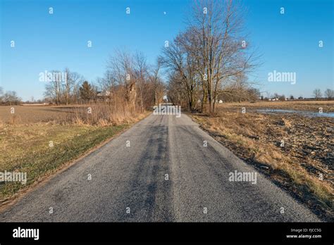 Rural Country Road Through Cornfield In Winter Indiana Usa Stock