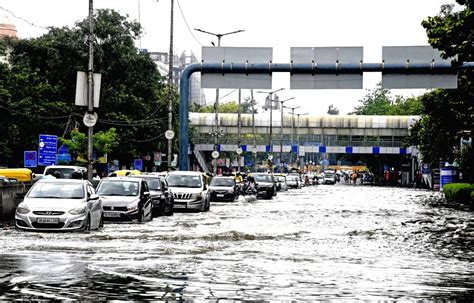 Vehicles Wade Through A Waterlogged Road