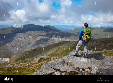 Hiker Looking Over The Beara Peninsula From The Summit Of Hungry Hill