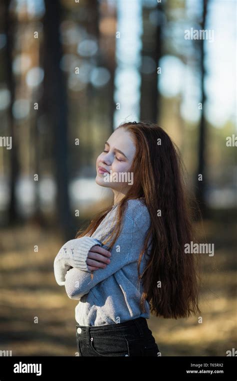 Twelve Year Old Cute Girl With Long Red Hair Posing For The Camera In