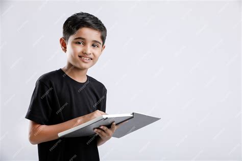 Premium Photo Cute Little Indian Asian Boy Reading Book Isolated