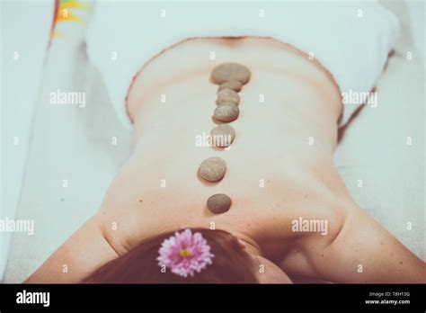 Beautiful Girl In Spa Salon Adult Woman Having Hot Stone Massage In Spa Salon Beauty Treatment