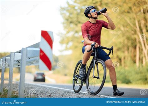 Tired Road Cyclist Refreshing With Water After Ride Stock Image Image