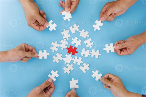 Hands Of Diverse People Assembling Jigsaw Puzzle Team Put Pieces