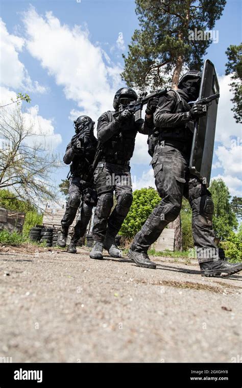 Spec Ops Police Officers Swat In Black Uniform In Action Stock Photo