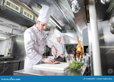 Chef Cutting Meat On Chopping Board Professional Cook Holding Knife